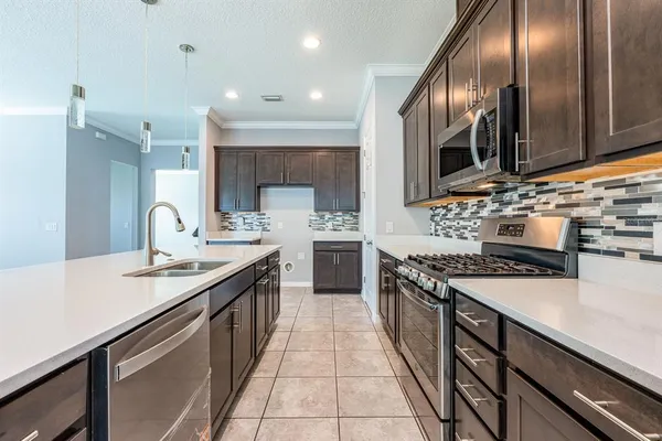 a kitchen with stainless steel appliances granite countertop a sink and stove