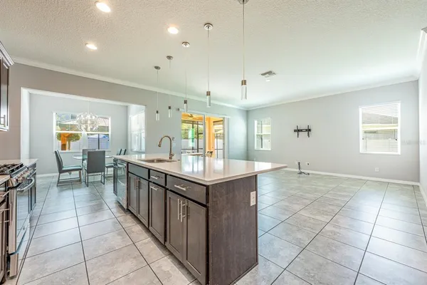 a kitchen with granite countertop a sink a counter top space and stainless steel appliances