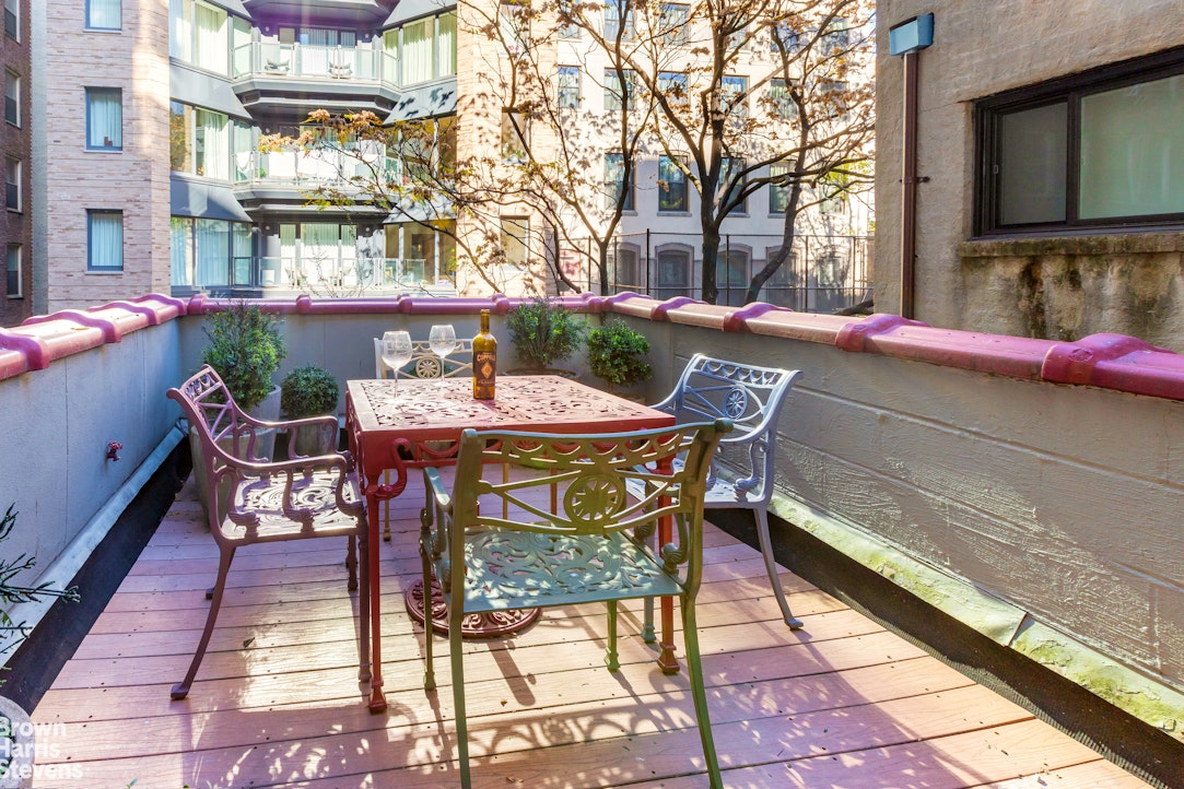 a view of a chairs and table on the patio