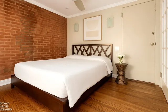 a large bed sitting in a bedroom next to a window