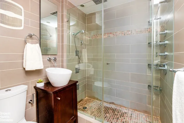 a bathroom with a sink toilet and shower