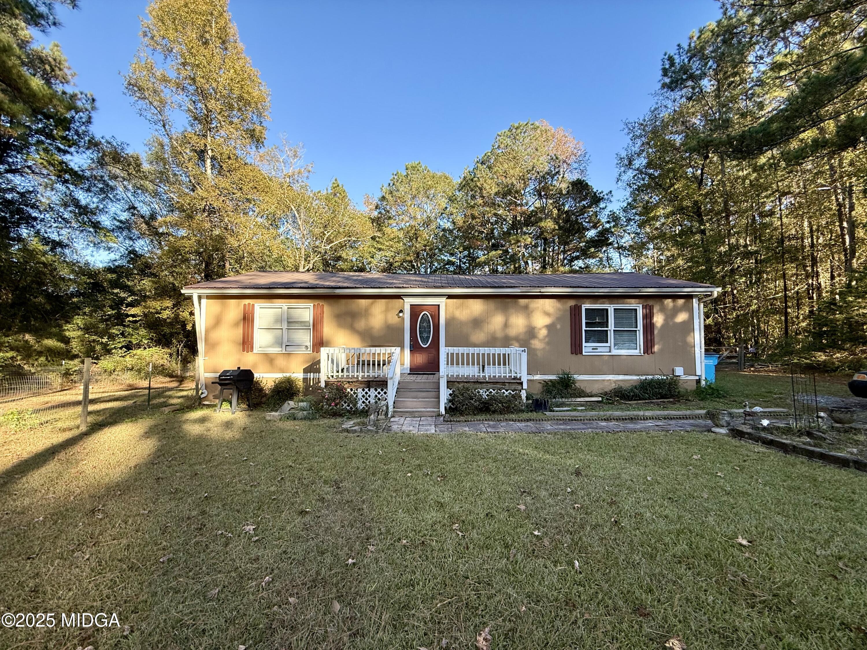 89 Springdale Road Jackson, GA 30233 - Photo 1 of 13 a view of a house with backyard and sitting area