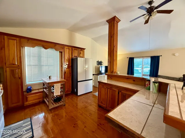 a view of a living room with furniture and a large window