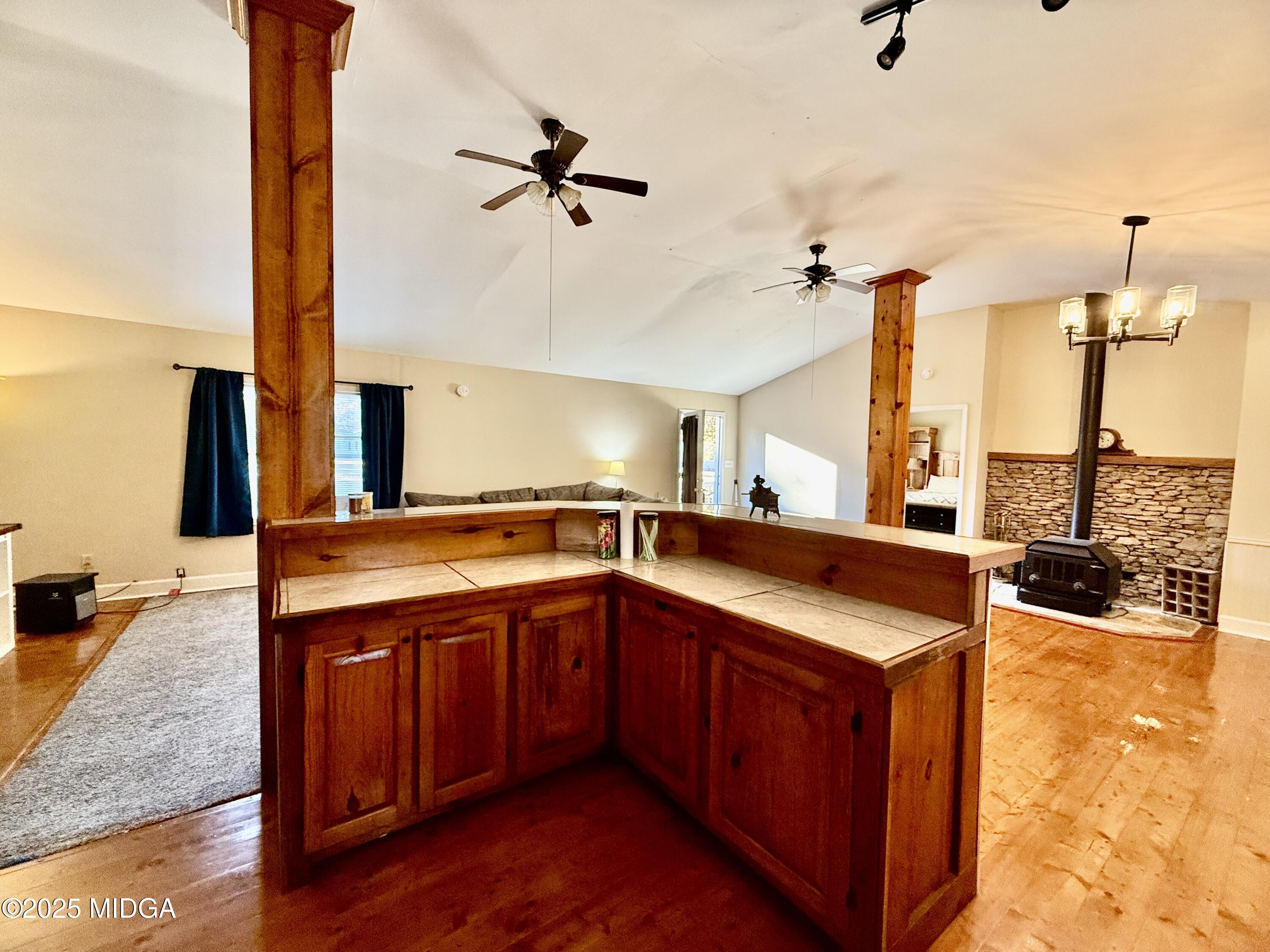 89 Springdale Road Jackson, GA 30233 - Photo 6 of 13 a kitchen with a sink and a stove with wooden floor