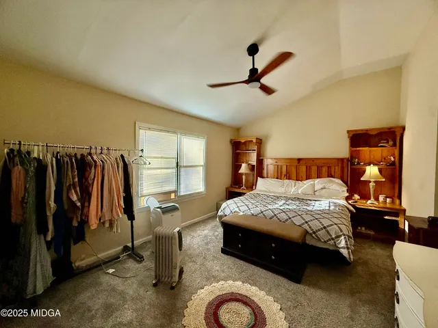 a bedroom with a bed closet and window