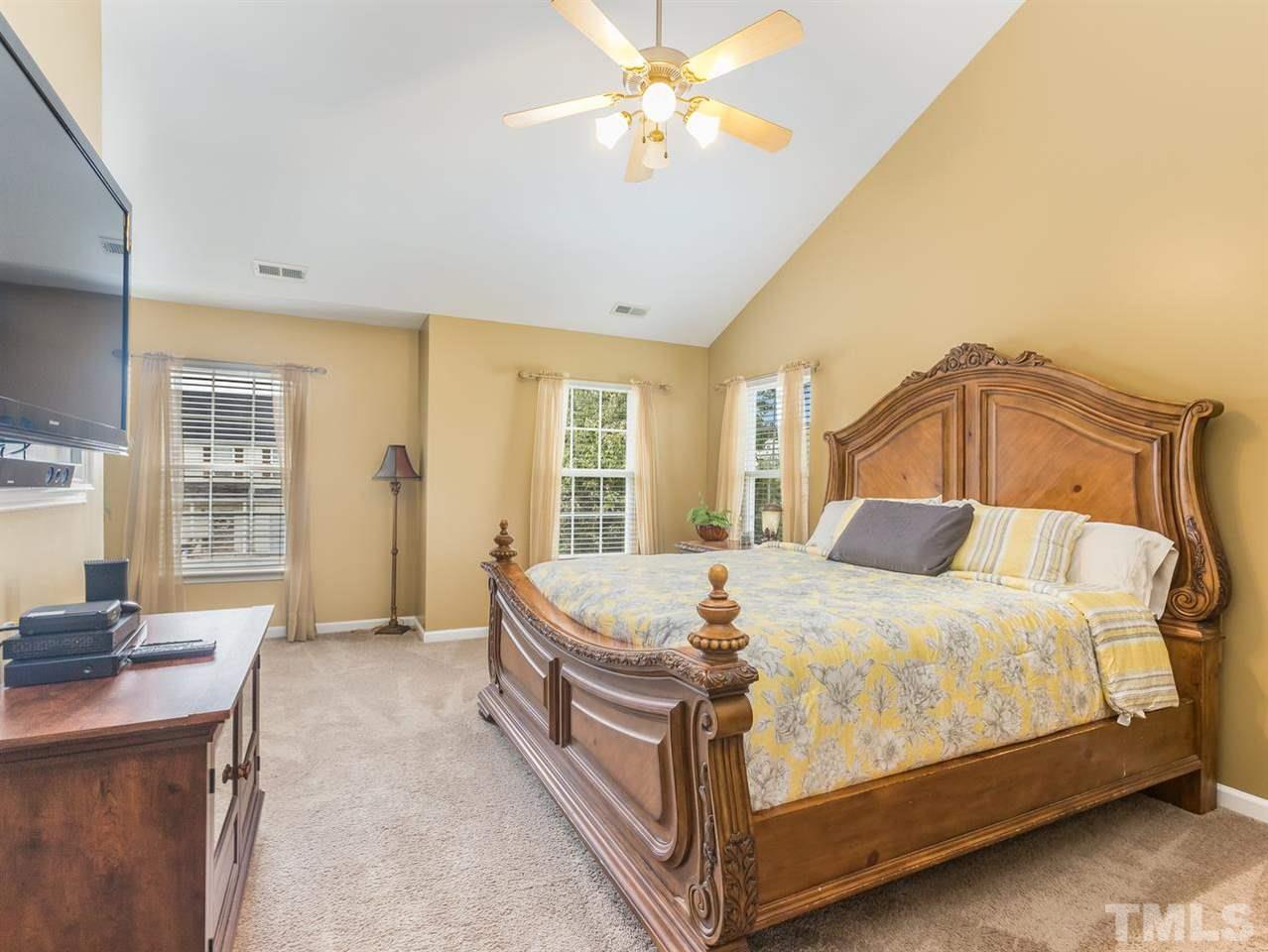 7021 Spanglers Spring Way Raleigh, NC 27610 - Photo 11 of 18 a bed sitting in a spacious bedroom next to a window