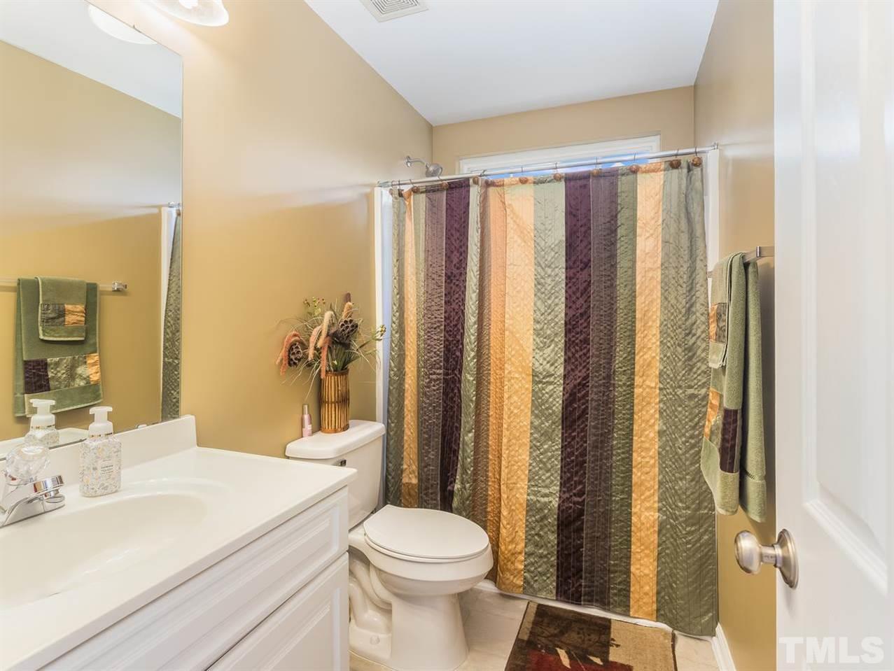 7021 Spanglers Spring Way Raleigh, NC 27610 - Photo 18 of 18 a bathroom with a sink a toilet and shower