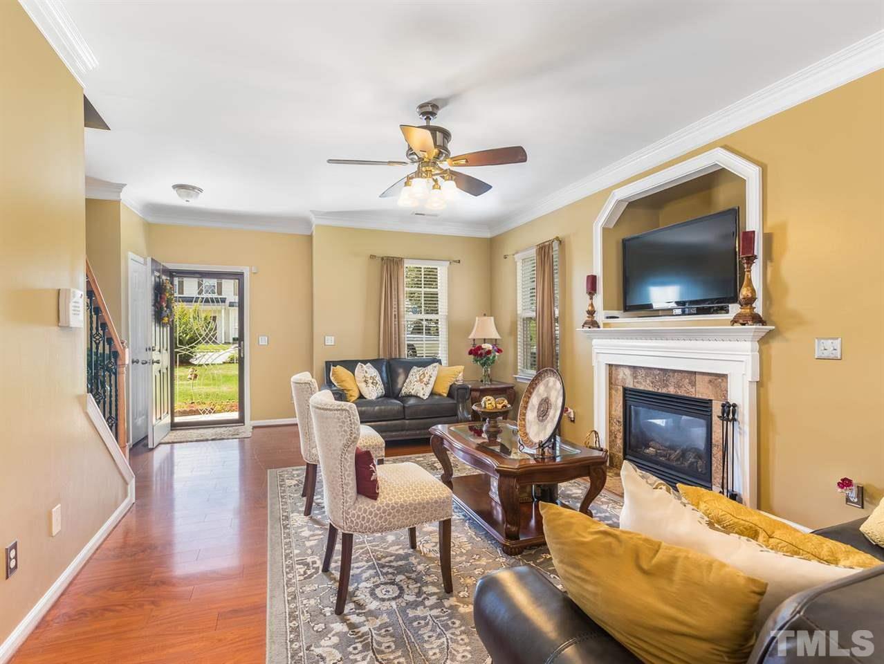 7021 Spanglers Spring Way Raleigh, NC 27610 - Photo 4 of 18 a living room with furniture fireplace and flat screen tv