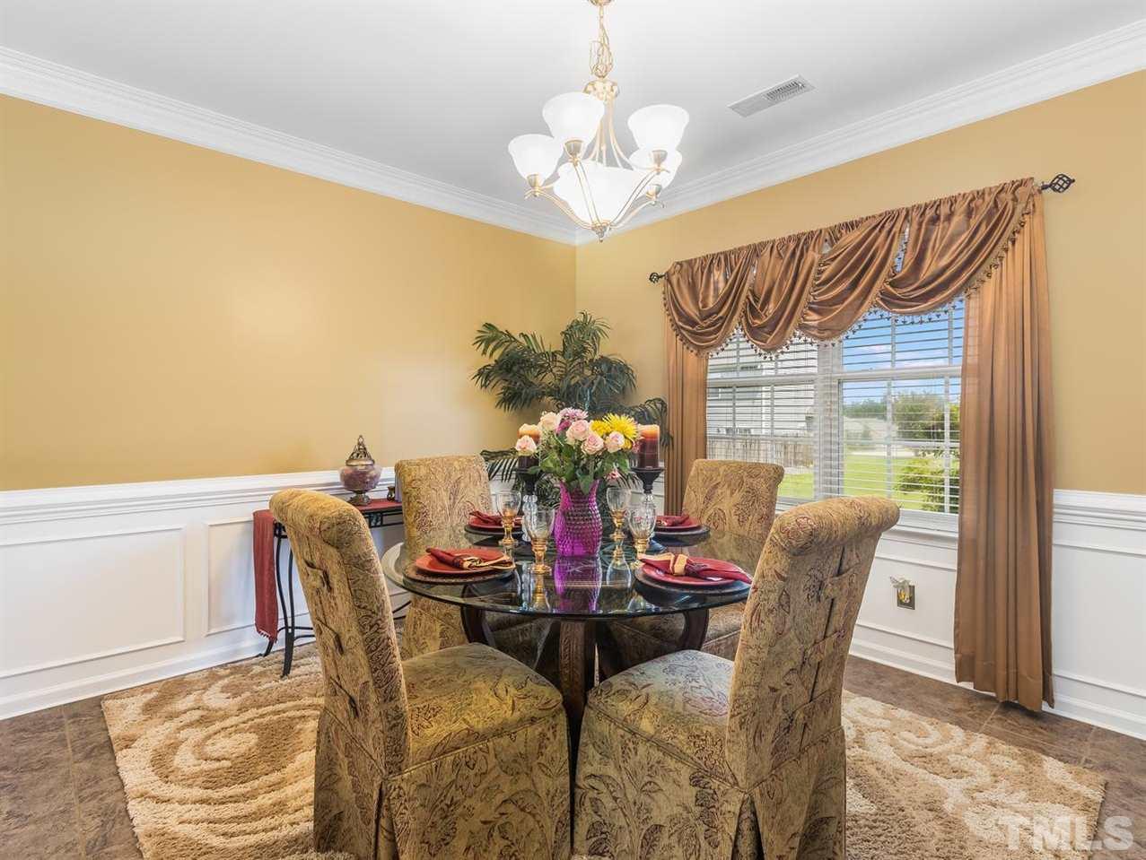 7021 Spanglers Spring Way Raleigh, NC 27610 - Photo 5 of 18 a view of a dining room with furniture and chandelier