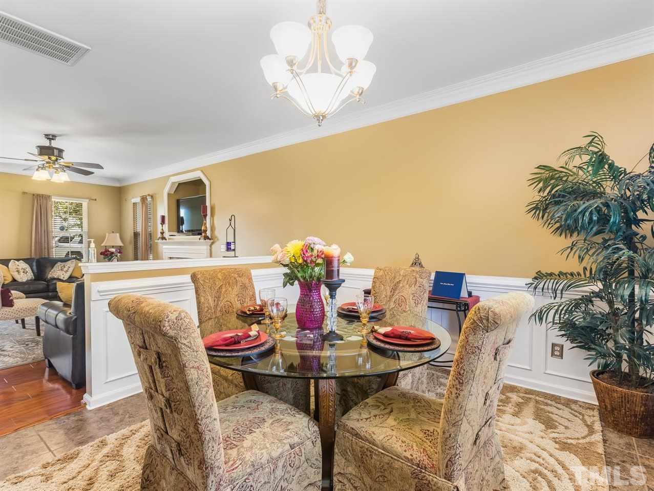 7021 Spanglers Spring Way Raleigh, NC 27610 - Photo 6 of 18 a view of a dining room with furniture and a potted plant