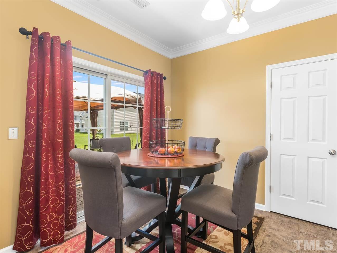 7021 Spanglers Spring Way Raleigh, NC 27610 - Photo 8 of 18 a view of a dining room with furniture window and wooden floor