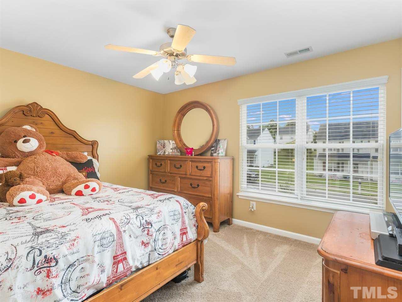 7021 Spanglers Spring Way Raleigh, NC 27610 - Photo 10 of 18 a bedroom with a bed and a large window with the outer view