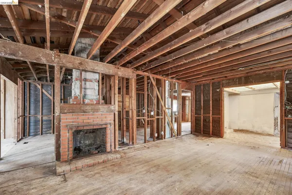 a view of an empty room with a fireplace