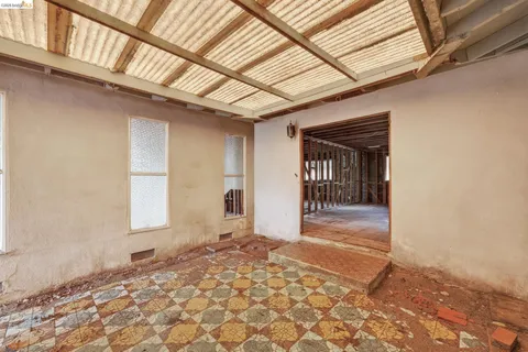 a view of a hallway with wooden walls and windows