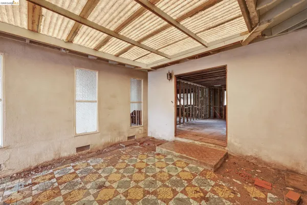 a view of a hallway with wooden walls and windows