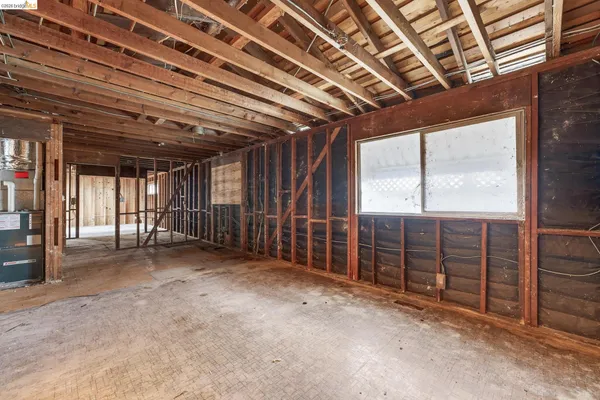 a view of empty room with wooden ceiling