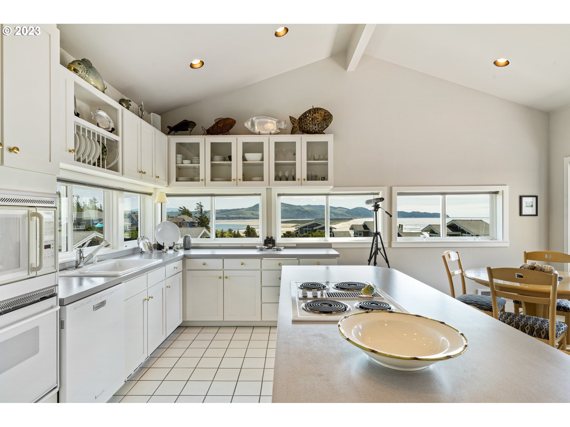 535 Capes Point Oceanside, OR 97141 - Photo 11 of 48 a kitchen with a sink and white cabinets