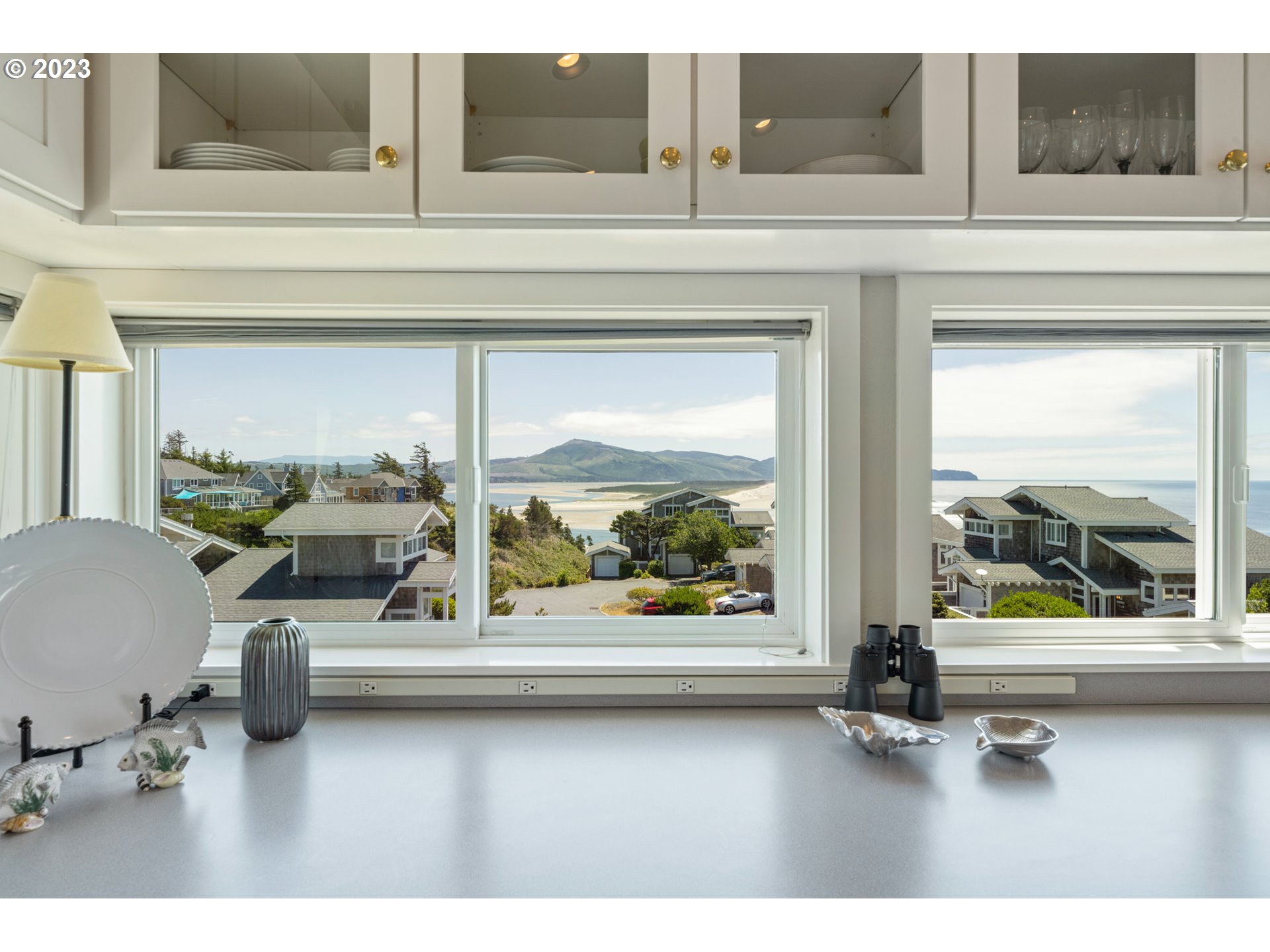 535 Capes Point Oceanside, OR 97141 - Photo 13 of 48 a living room with furniture and a floor to ceiling window
