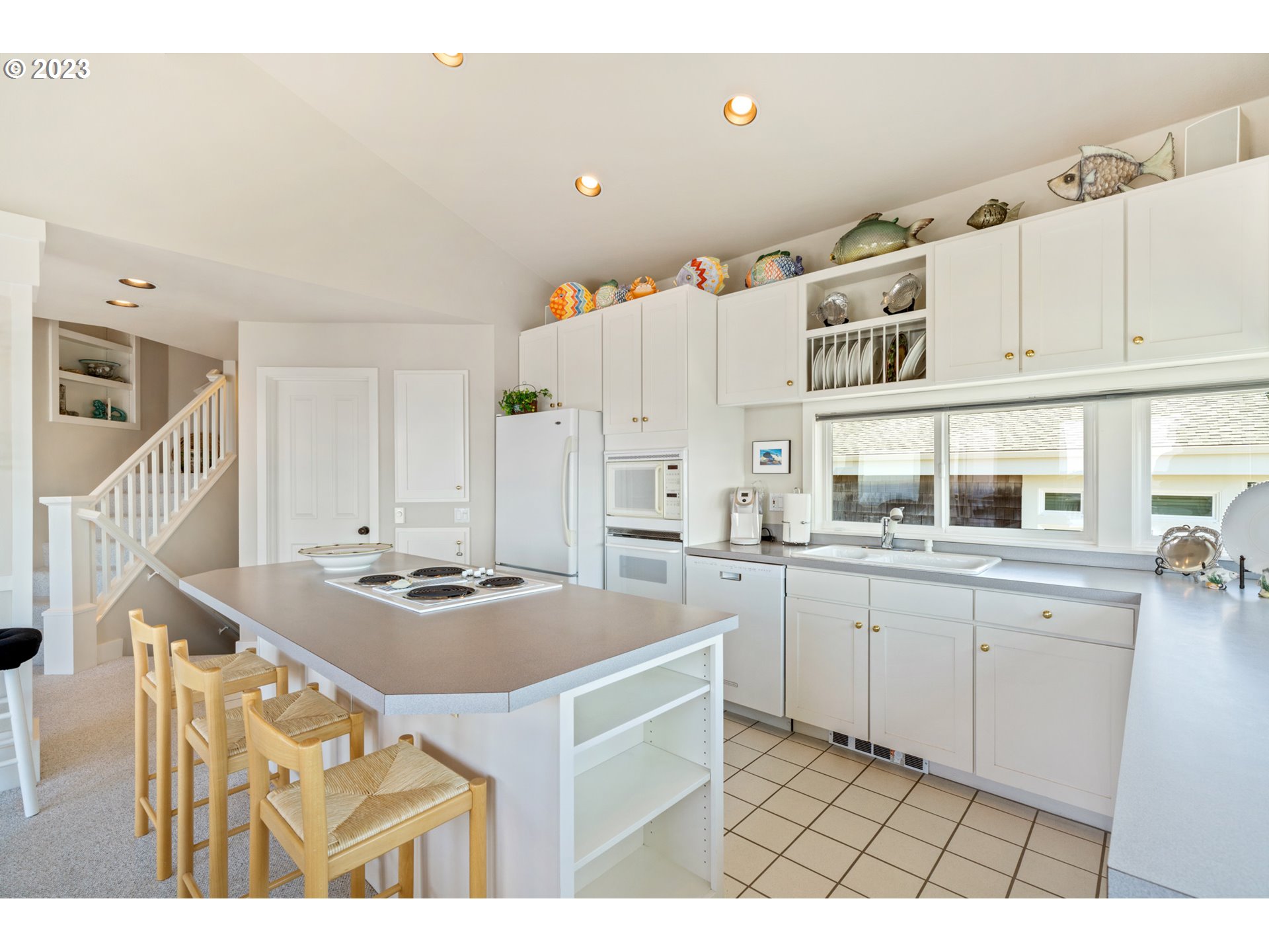 535 Capes Point Oceanside, OR 97141 - Photo 16 of 48 a kitchen with cabinets and window