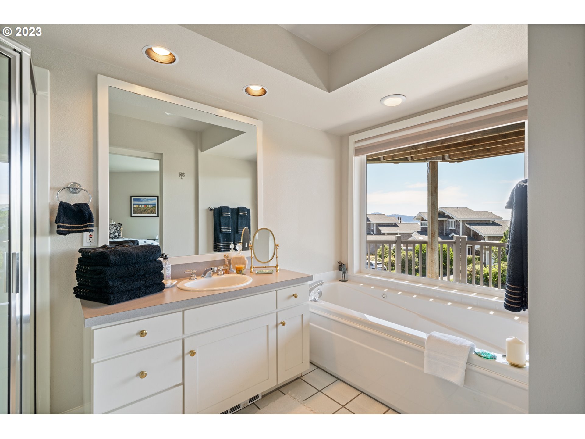 535 Capes Point Oceanside, OR 97141 - Photo 20 of 48 a en suite bathroom with a tub double vanity window and a sink