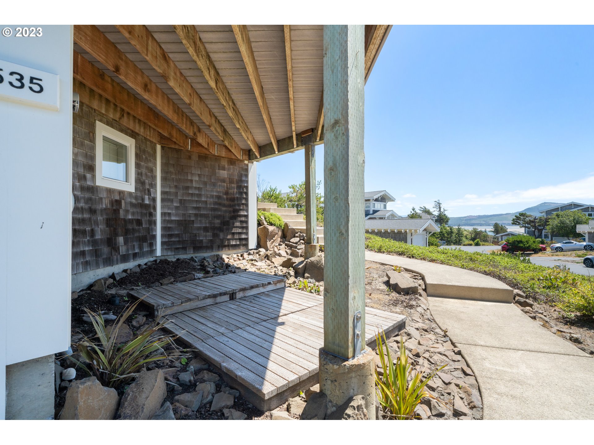 535 Capes Point Oceanside, OR 97141 - Photo 33 of 48 a view of a patio with table and chairs with wooden floor and fence