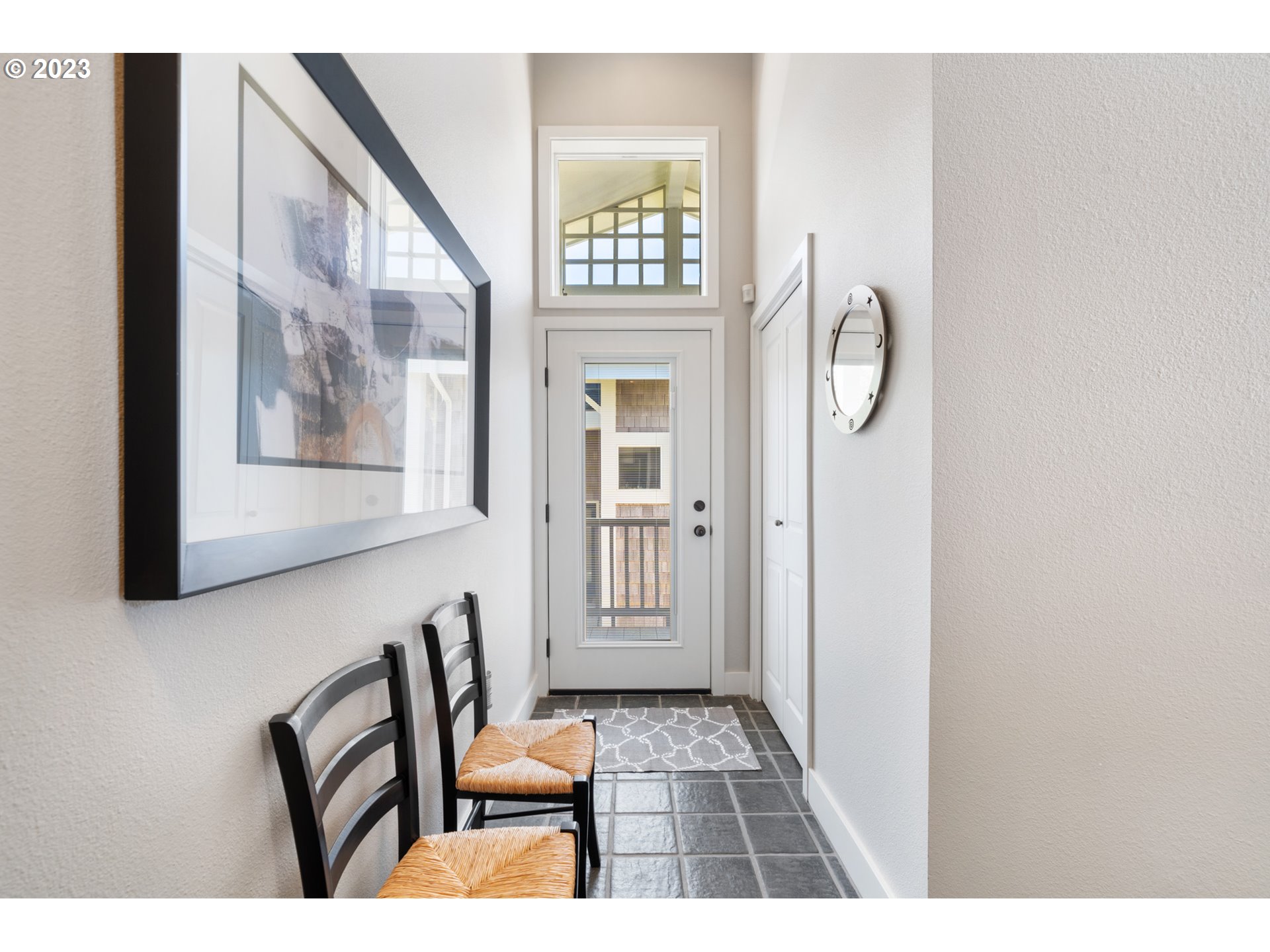535 Capes Point Oceanside, OR 97141 - Photo 36 of 48 a view of a hallway with wooden floor and a large window