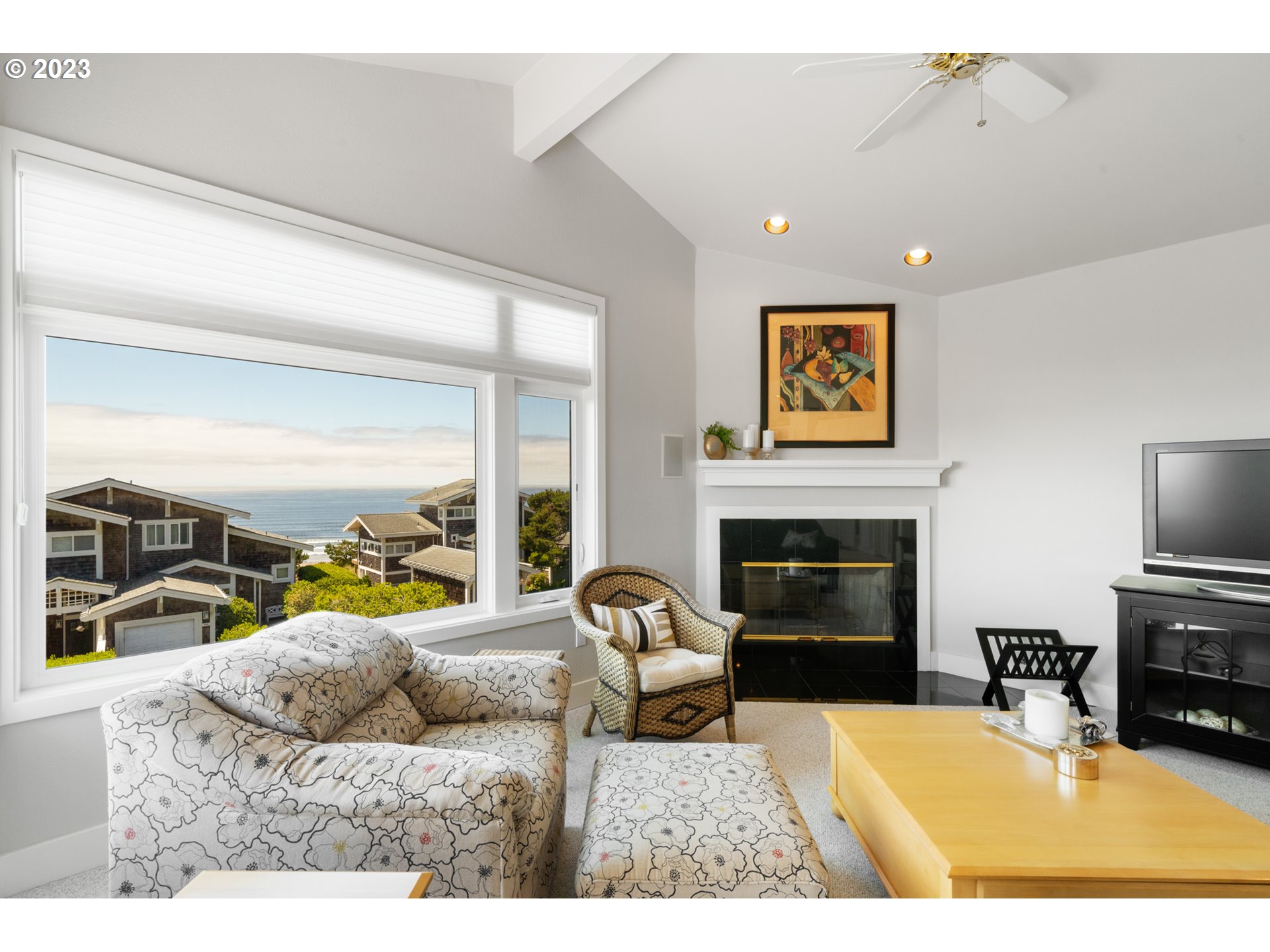 535 Capes Point Oceanside, OR 97141 - Photo 38 of 48 a living room with furniture a fireplace and a flat screen tv