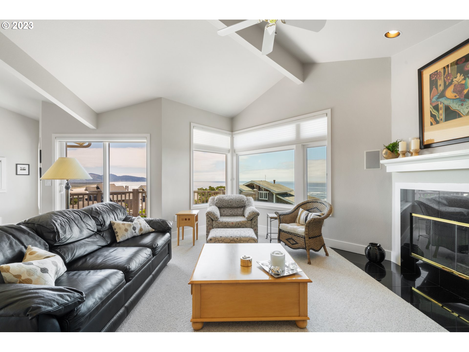 535 Capes Point Oceanside, OR 97141 - Photo 5 of 48 a living room with furniture a large window and a fireplace