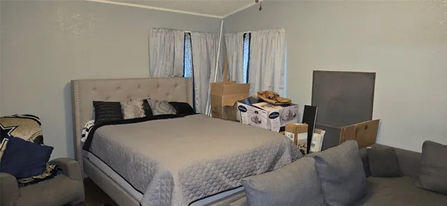 a bed room with a bed and a chair