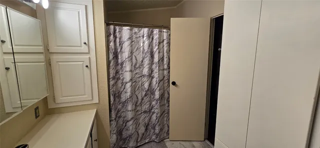 a bathroom with a shower and a tub