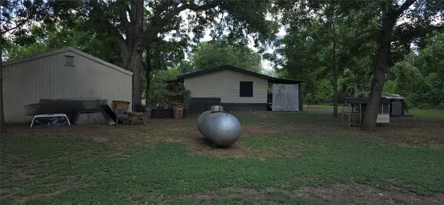 a backyard of a house with table and chairs
