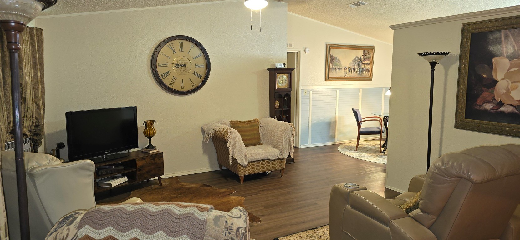 2002 Citation Drive Del Valle, TX 78617 - Photo 10 of 25 a living room with furniture a clock on the wall and a flat screen tv