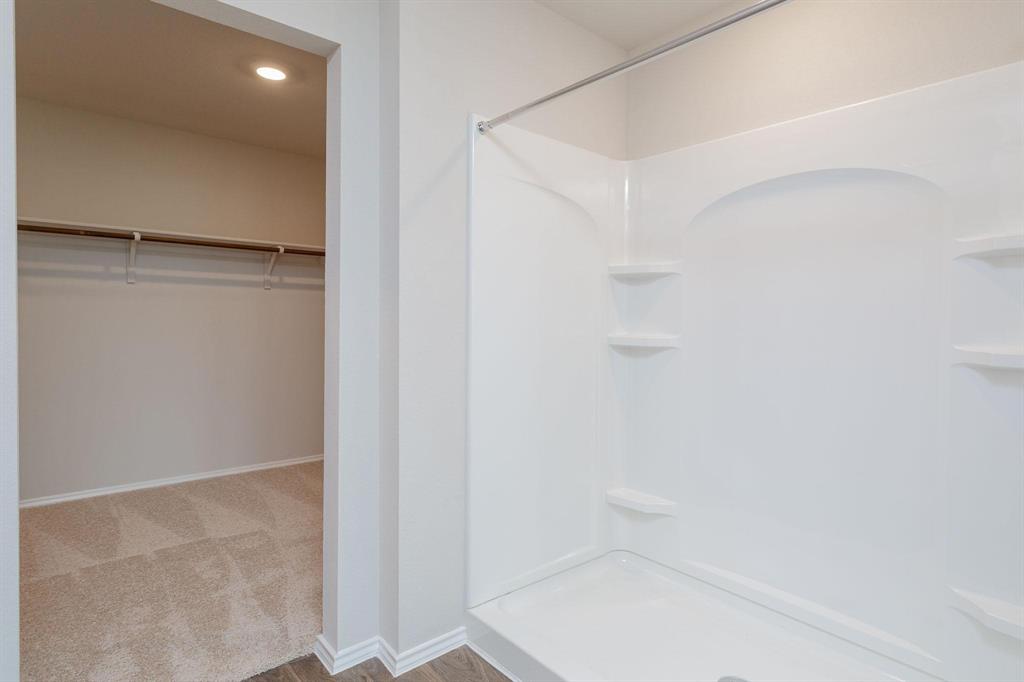 6009 Ronee Leah Drive Austin, TX 78724 - Photo 11 of 16 A well-lit shower area provides a convenient and private space for daily routines.