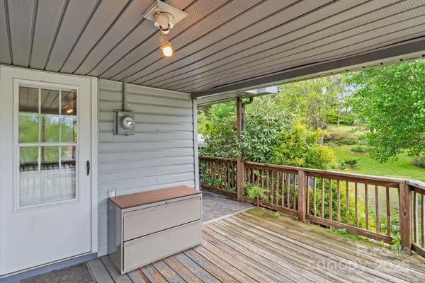 a view of a wooden deck next to a yard