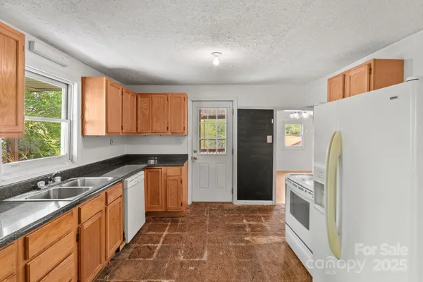 a kitchen with appliances cabinets and a sink