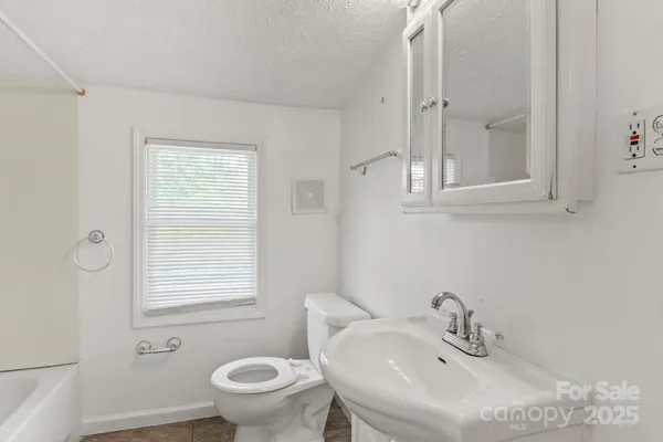 an empty room with closet and a window
