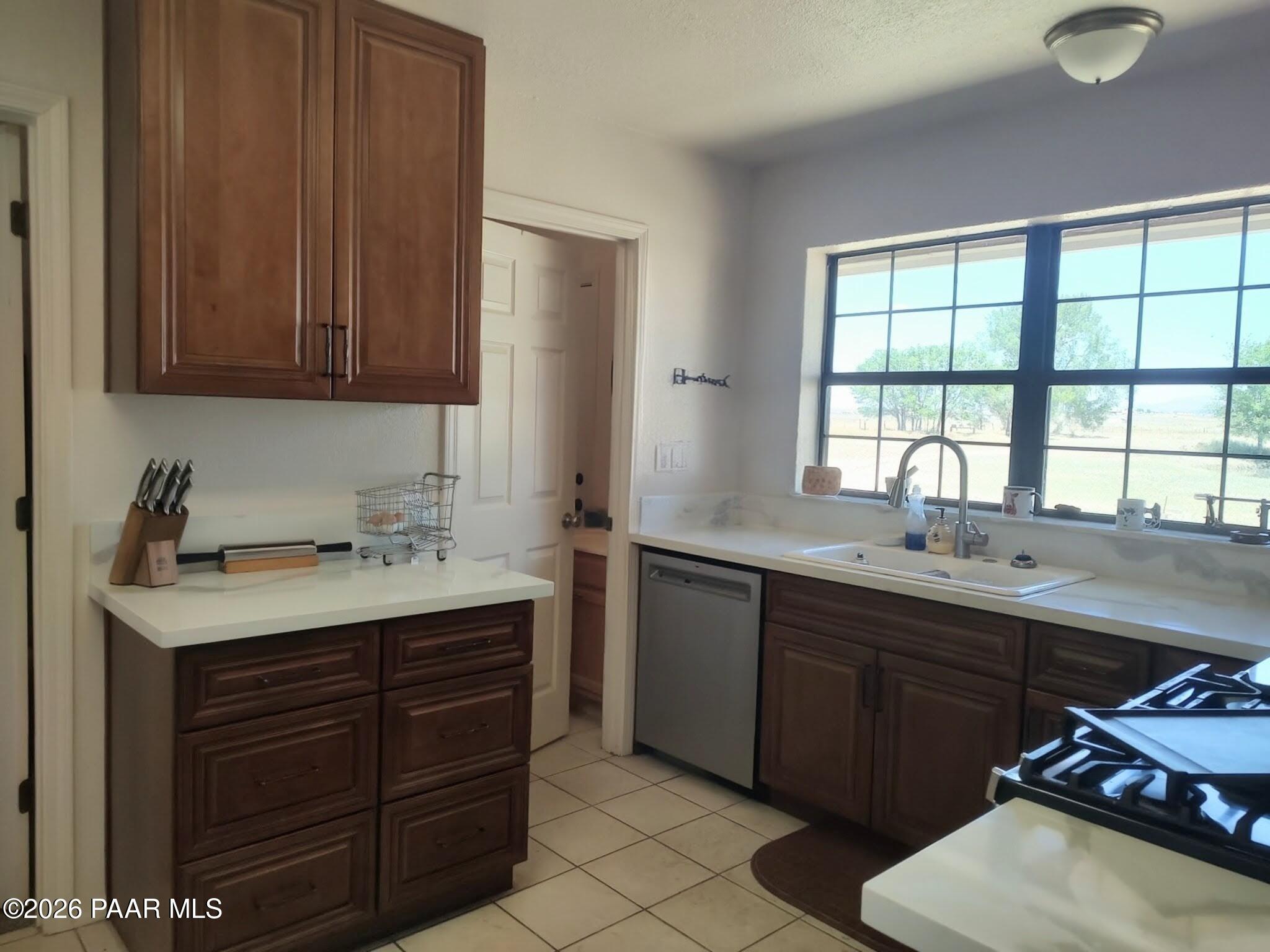 3980 West Rocky Road Paulden, AZ 86334 - Photo 10 of 32 a kitchen with a sink and wooden cabinets