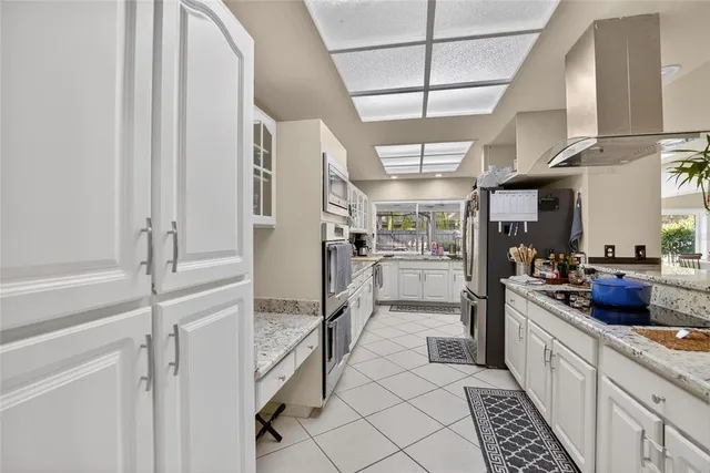 a living room with furniture a rug and a chandelier