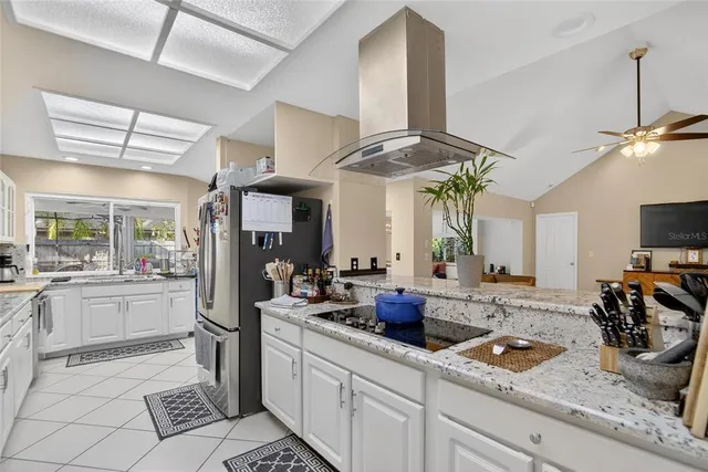 a living room with fireplace furniture and a chandelier