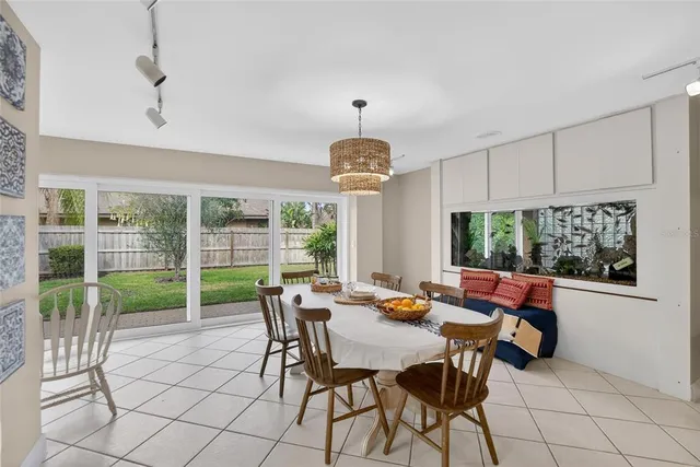 a living room with a flat screen tv and a ceiling fan