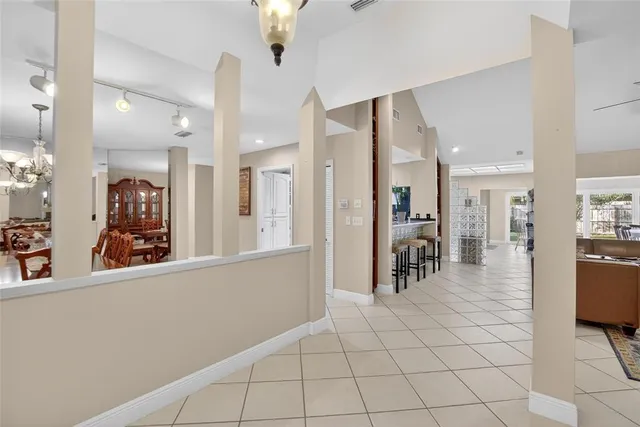 a view of a dining room with furniture and chandelier