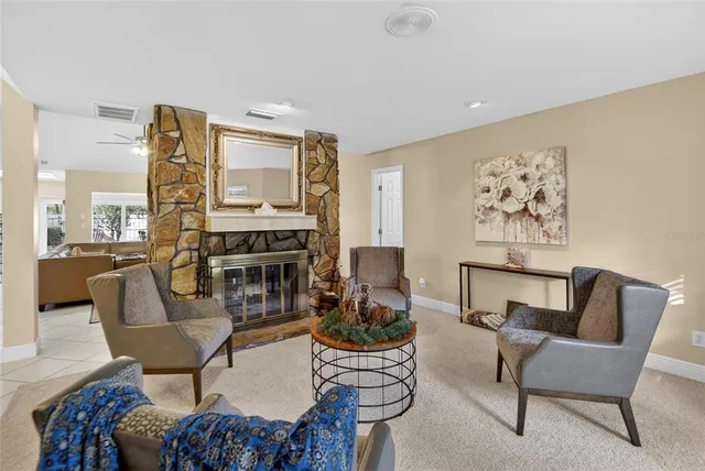 a view of a dining room and livingroom with furniture wooden floor a chandelier