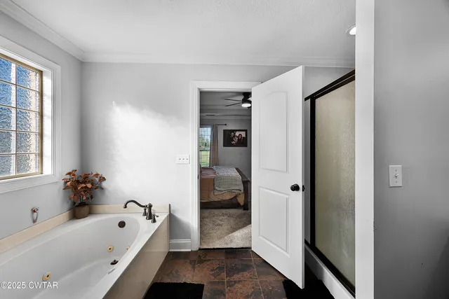 a bathroom with a tub shower and a sink
