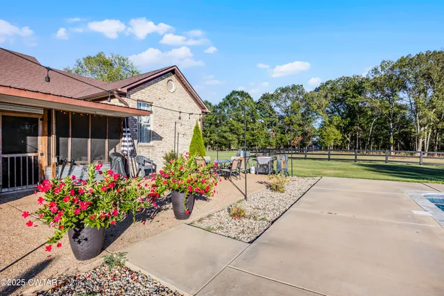 a view of a backyard with sitting area