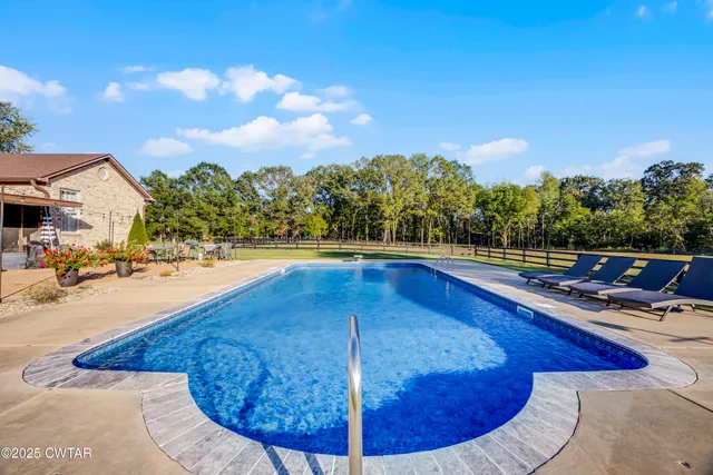 a view of a swimming pool with a lounge chair