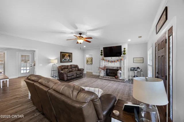 a living room with furniture a fireplace and a flat screen tv