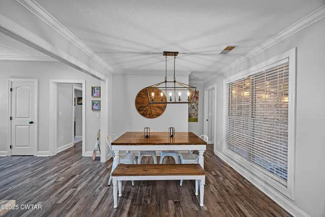 a living room with a table and chairs