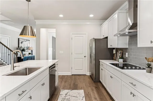 a kitchen with a sink a refrigerator and cabinets