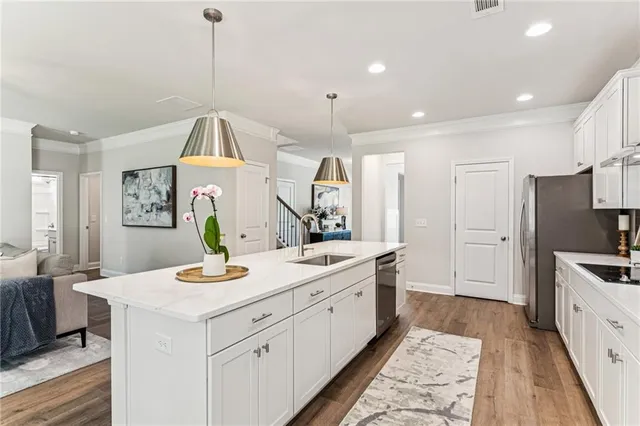 a view of a kitchen counter space a sink a window and stainless steel appliances