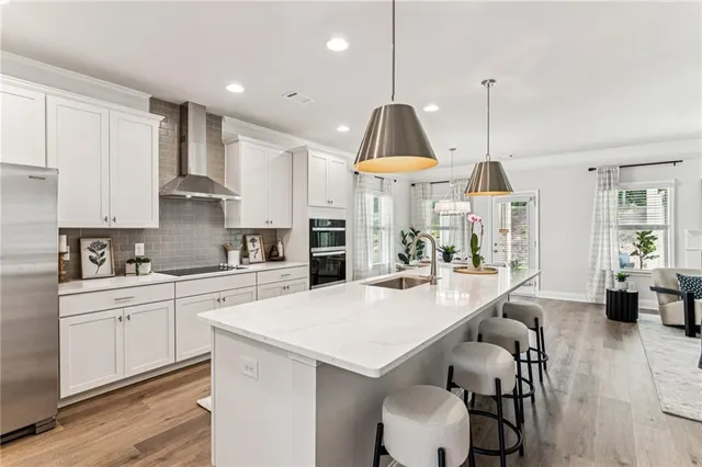 a kitchen with stainless steel appliances a center island appliances and cabinets